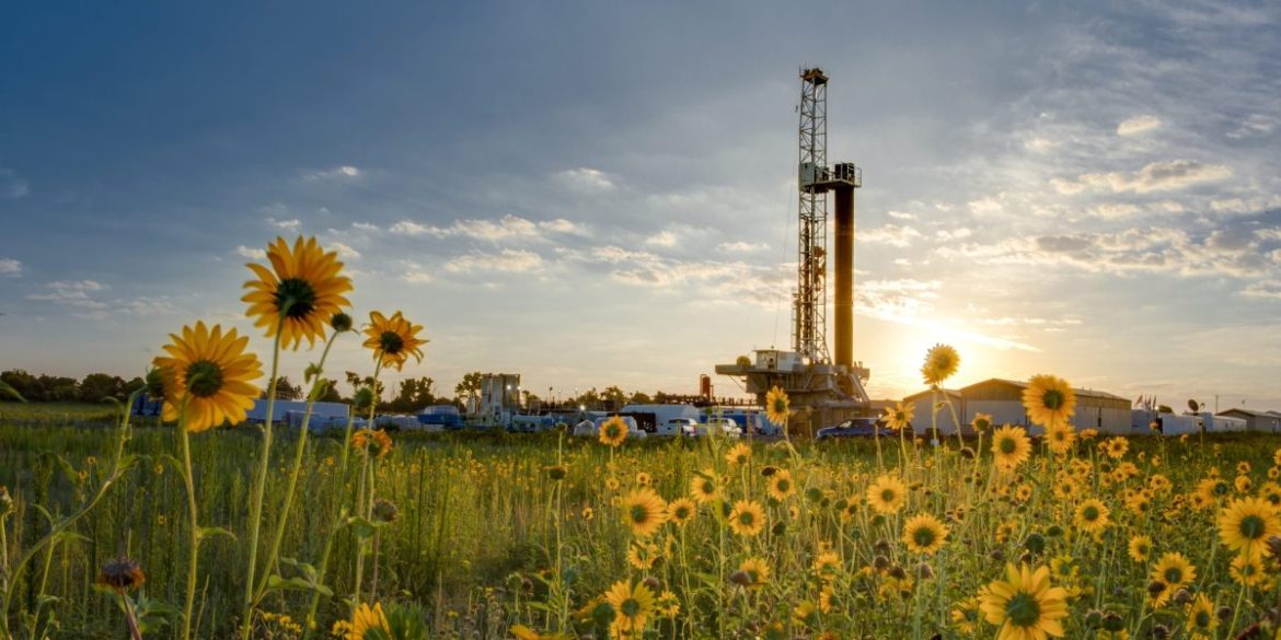 A Devon Energy drilling rig spread is pictured amid sunflowers in Oklahoma's Anadarko Basin.
